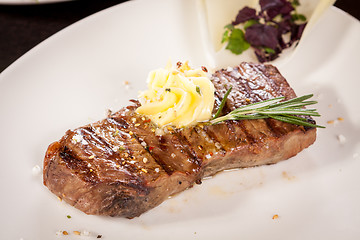 Image showing Grilled beef steak topped with butter and rosemary