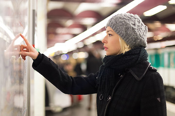 Image showing Lady looking on public transport map panel.