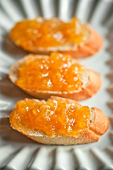 Image showing pieces of baguette with orange marmalade