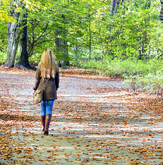 Image showing Young woman walking in park