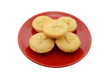 Image showing Five homemade mince pies on a festive red plate