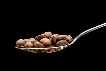 Image showing Spoon with coffee beans isolated.
