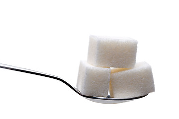 Image showing Spoon with sugar cubes isolated