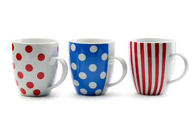 Image showing Three porcelain cup in colored stripes and dots