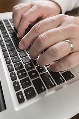 Image showing Male Hands Typing on Laptop Computer