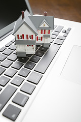 Image showing Miniature House on Laptop Computer