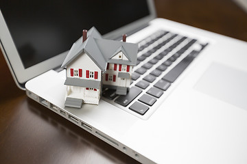 Image showing Miniature House on Laptop Computer