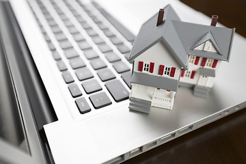 Image showing Miniature House on Laptop Computer