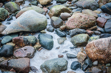 Image showing The freezed stones on coast of Baltic sea. A winter landscape