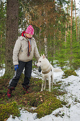 Image showing The woman with a dog on walk in a winter wood