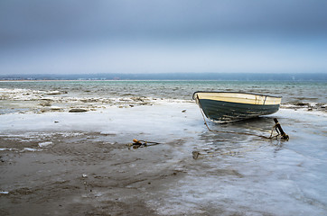 Image showing Fishing boat on the shore of the Baltic Sea. Winter landscape