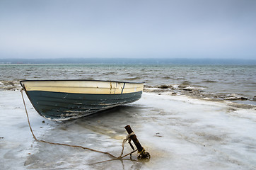 Image showing Fishing boat on the shore of the Baltic Sea. Winter landscape