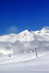 Image showing Winter snowy mountains and cable car at nice day