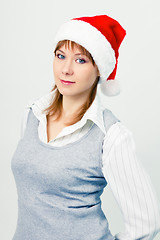 Image showing Attractive girl in santa hat. Portrait