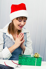 Image showing girl in the office in Santa hats with a gift