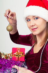 Image showing happy girl in santa hat with gift boxes