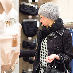 Image showing Beautiful lady shopping in lingerie store.