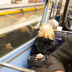 Image showing Woman looking out metro's window.