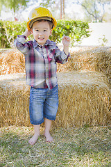 Image showing Young Mixed Race Boy Laughing with Hard Hat Outside