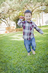 Image showing Cute Young Mixed Race Boy Playing Football Outside