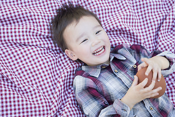 Image showing Young Mixed Race Boy Playing with Football on Picnic Blanket