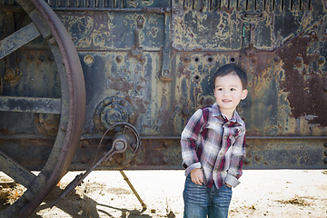 Image showing Cute Young Mixed Race Boy Having Fun Near Antique Machinery