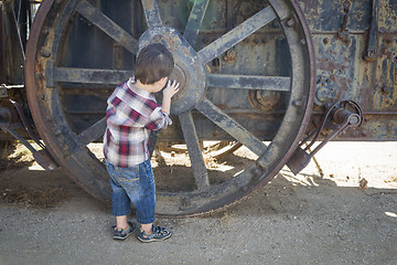 Image showing Cute Young Mixed Race Boy Having Fun Near Antique Machinery