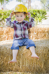 Image showing Young Mixed Race Boy Laughing with Hard Hat Outside