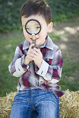 Image showing Cute Young Mixed Race Boy Looking Through Magnifying Glass