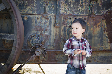 Image showing Cute Young Mixed Race Boy Having Fun Near Antique Machinery
