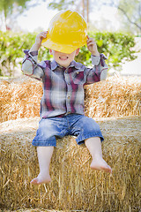 Image showing Young Mixed Race Boy Laughing with Hard Hat Outside