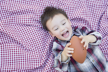 Image showing Young Mixed Race Boy Playing with Football on Picnic Blanket