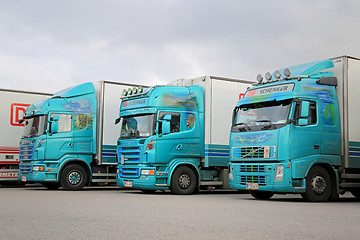 Image showing Three Turquoise Trailer Trucks