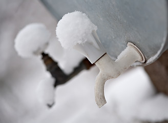 Image showing two outdoor metal faucets covered by snow