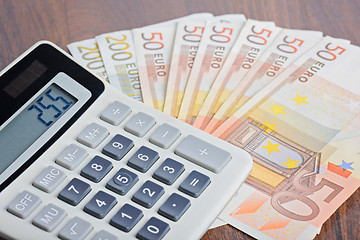 Image showing Calculator and banknotes on the table