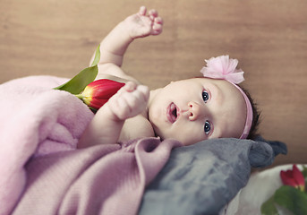 Image showing Baby with pink blanket and flower