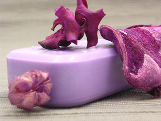 Image showing Lilac soap with decoration articles on a  gray  background