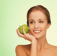 Image showing smiling young woman with green apple