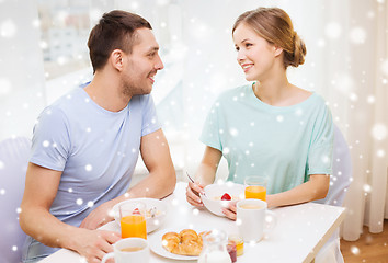 Image showing smiling couple having breakfast at home