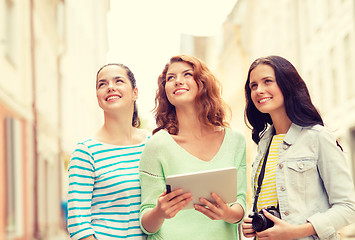 Image showing smiling teenage girls with tablet pc and camera