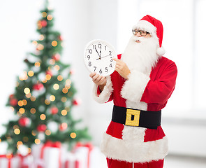 Image showing man in costume of santa claus with clock