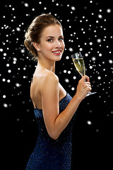 Image showing smiling woman holding glass of sparkling wine