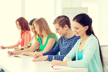 Image showing smiling students with textbooks at school