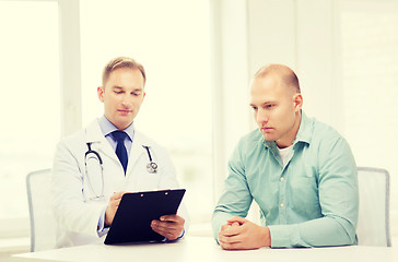 Image showing doctor with clipboard and patient in hospital