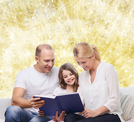 Image showing happy family with book at home