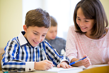 Image showing group of school kids writing test in classroom