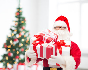 Image showing man in costume of santa claus with gift boxes