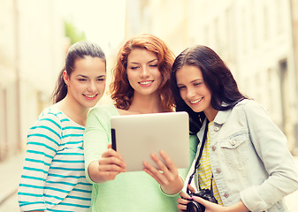 Image showing smiling teenage girls with tablet pc and camera