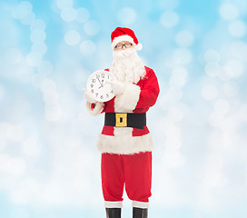 Image showing man in costume of santa claus with clock