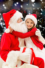 Image showing smiling little girl with santa claus and gifts